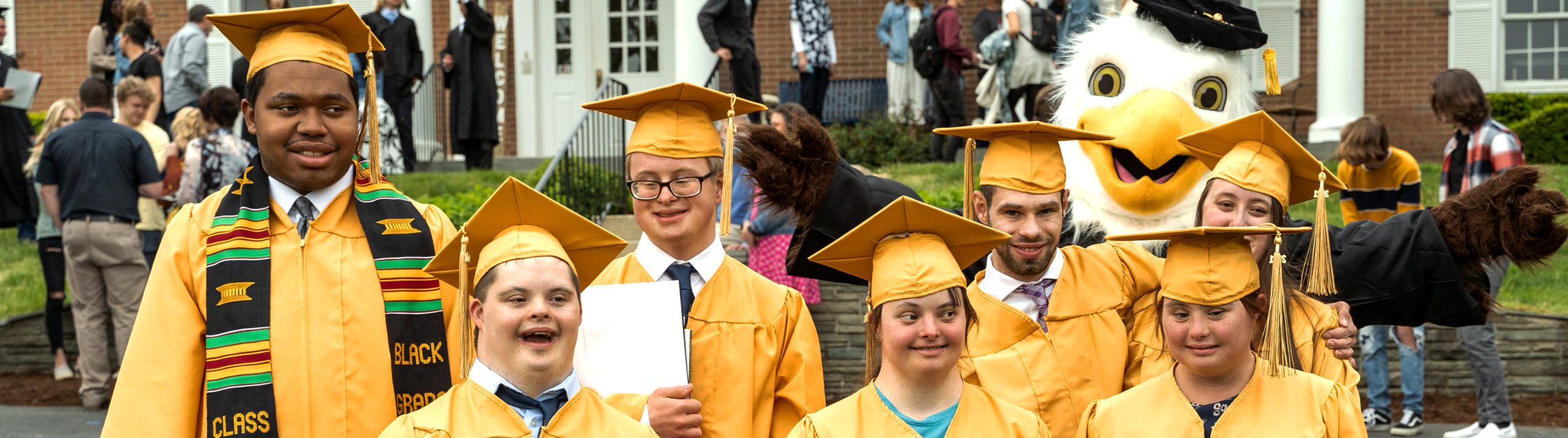 RISE students in caps and gowns at a spring graduation ceremony